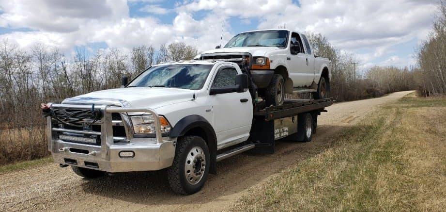 Car without wheels ready for specialty removal in Edmonton
